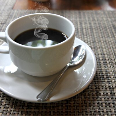 Hot Black coffee in a white cup on the table.