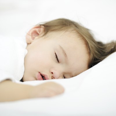 Baby sleeping on white bed