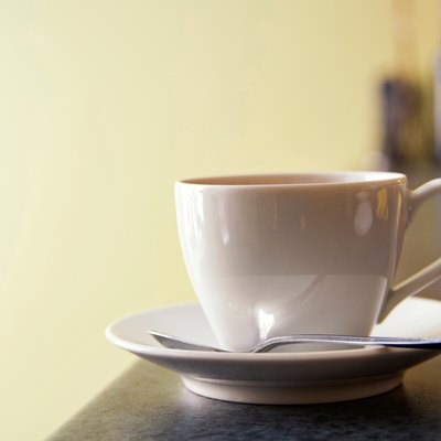 Cup and saucer of coffee on European cafe counter.
