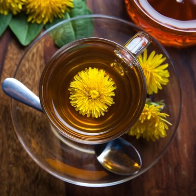 dandelion tisane tea with yellow blossom inside teacup