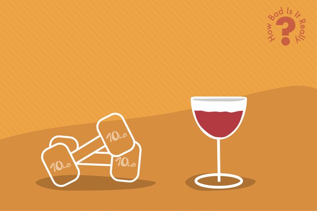Glass of wine next to weights