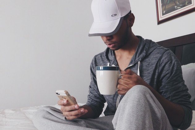 man checking his phone before bed
