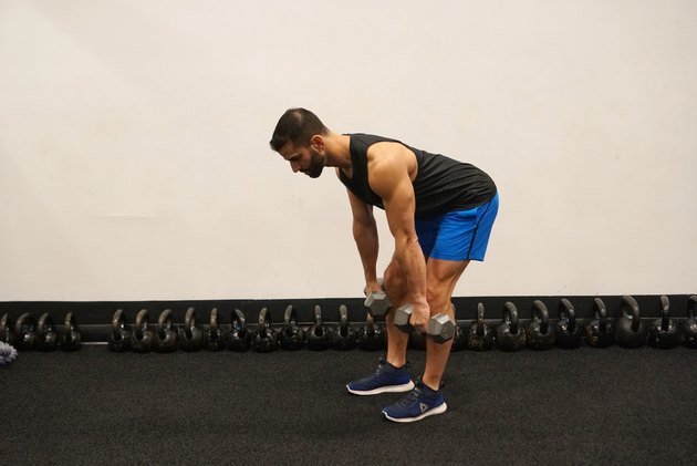 Man demonstrating how to do dumbbell romanian deadlifts