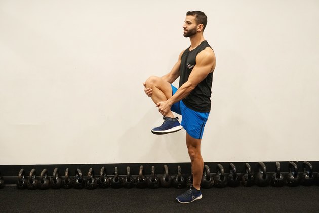 Man demonstrating how to do standing knee grab