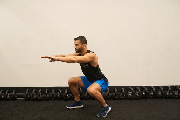 Man demonstrating how to do offset stance body-weight squats