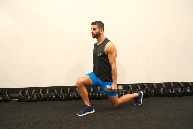 Man demonstrating how to do single dumbbell reverse lunges