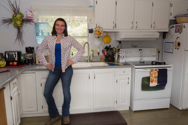Brittany stands in her kitchen.