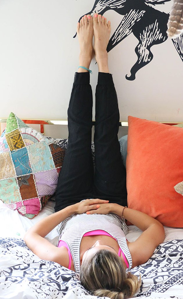 woman doing legs up the wall pose