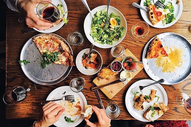 American foods like pizza and Cobb salad spread out on a table