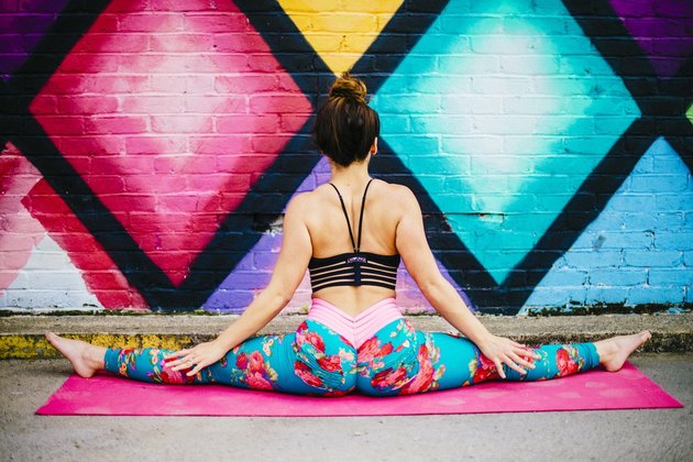 woman doing the splits in her gym clothes