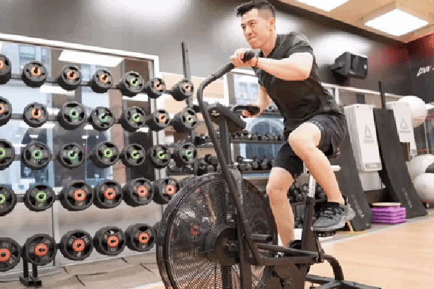 Man using assault bike.