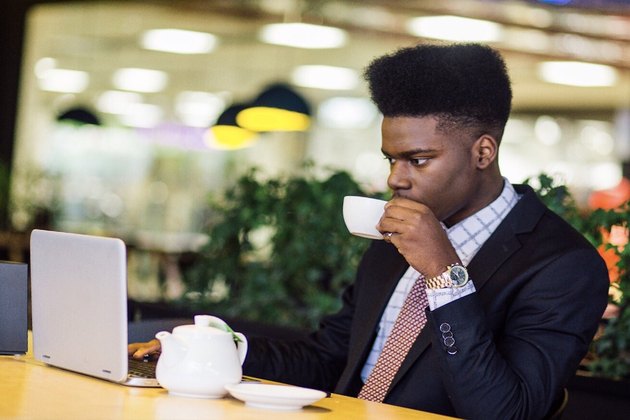 man sipping tea during a busy day