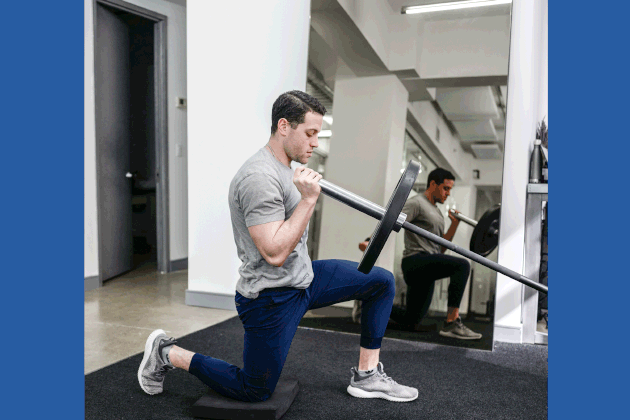Sam Becourtney Performing Half-Kneeling Single-Arm Landmine Press