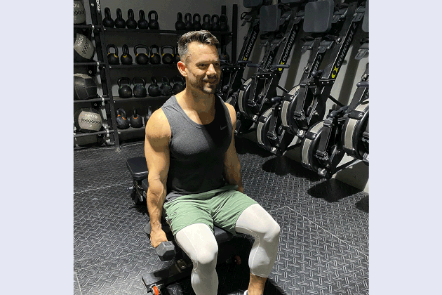 Mathew Forzaglia performing seated shoulder raise.