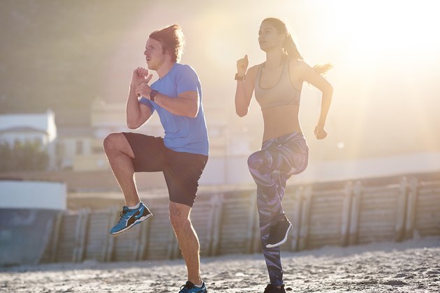 man and woman doing high knees cardio drill