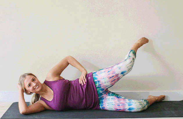 Woman demonstrating how to do side-lying leg lifts for an at-home barre workout