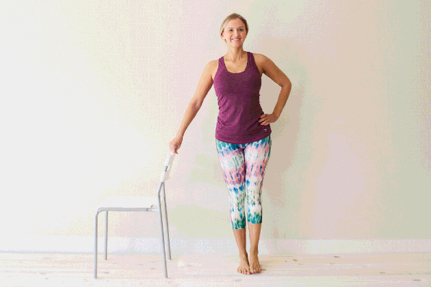 Woman demonstrating how to do side leg swings for an at-home barre workout
