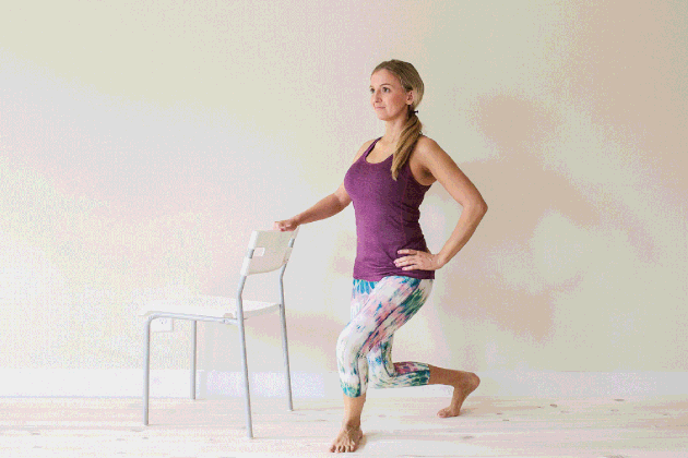 Woman demonstrating how to do a curtsy for an at-home barre workout