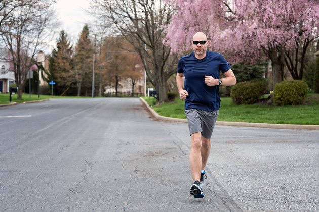 Scott runs down the street.