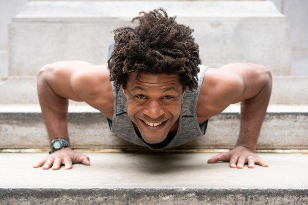 Errick smiles while doing a push-up