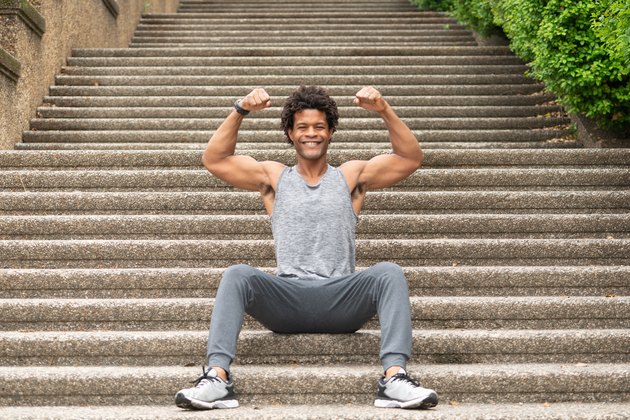 Errick flexes on the stairs
