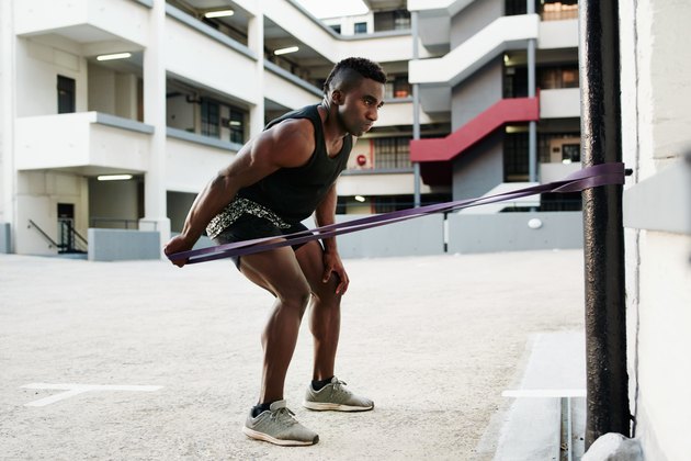Man using long looped resistance band.