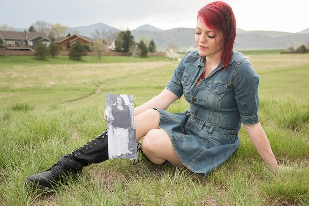 Alanna holds an old photo of herself