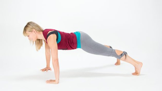 Elise Joan demonstrates how to do a Wide-Arm Plank