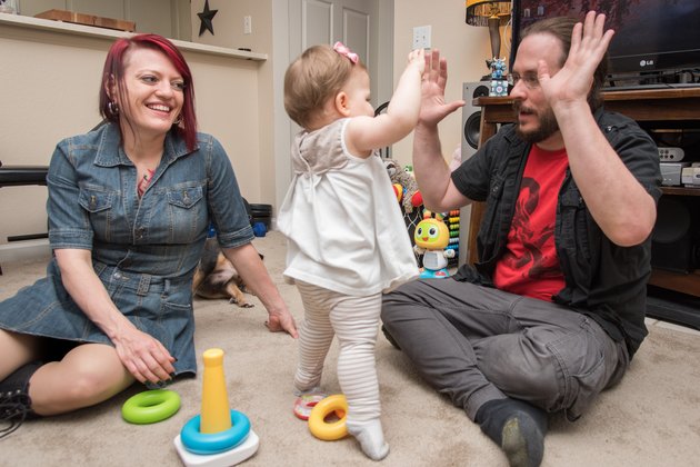 Alanna smiles at her husband and daughter