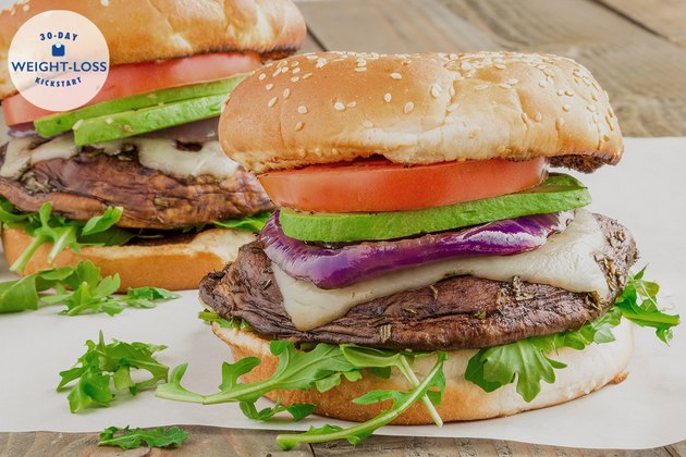 A portobello mushroom burger with lettuce, tomato, onion and cheese