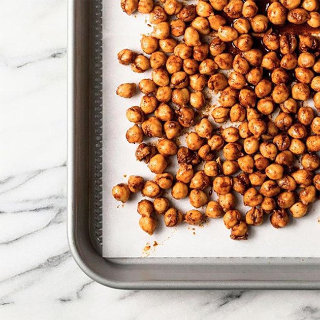 garbanzo beans on roasting pan with seasoning