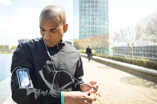 Man playing music on his iphone before a workout