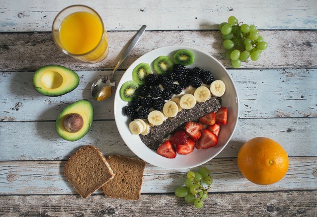 healthy smoothie bowl and fruit on a table for intermittent fasting
