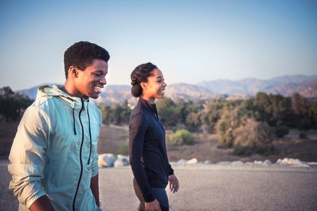 Woman and man walking a mile a day for weight loss exercise