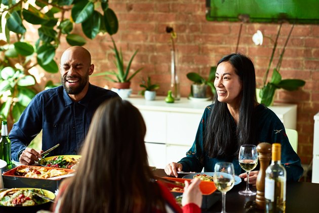 Couple eating at friend's dinner party