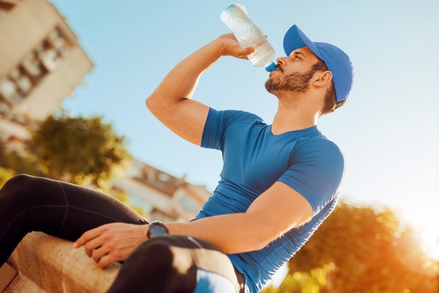 Thirsty athlete man drinking water