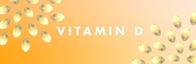 Vitamin D capsules in a pattern on a yellow background