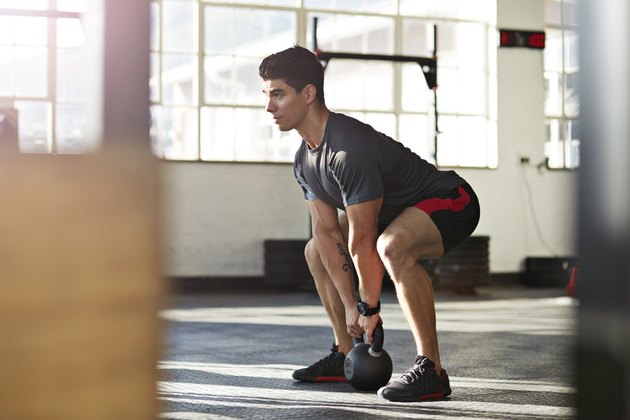 Man performing kettlebell deadlift.
