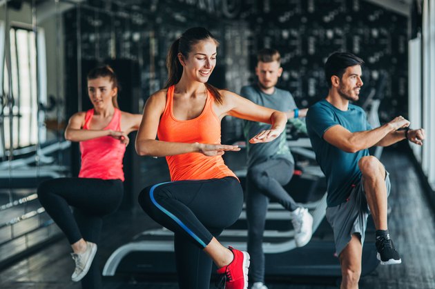 Women and men doing moves in an aerobic class