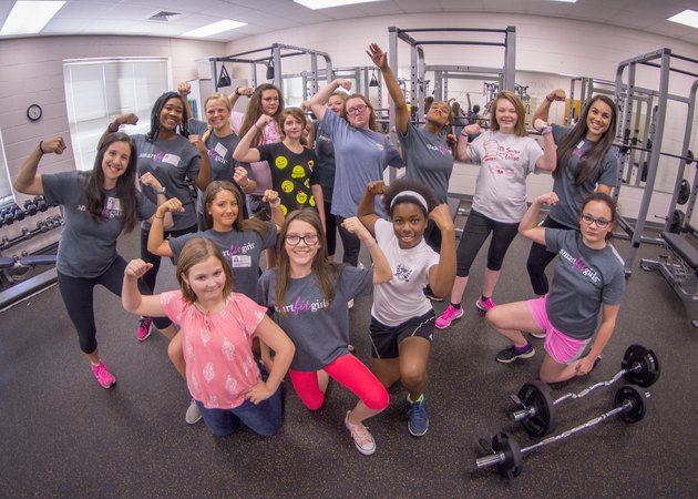 a group of girls participating in a fitness class through Smart Fit Girls