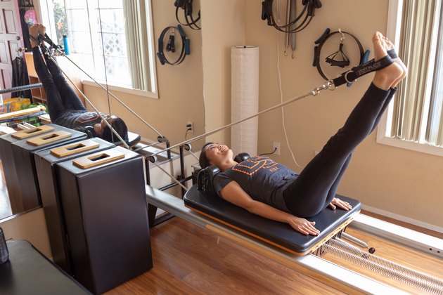 Kristina stretches on her Pilates Reformer.
