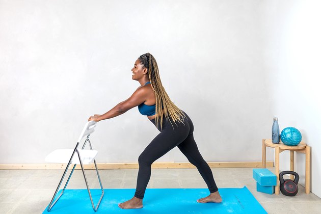 woman doing a standing calf stretch