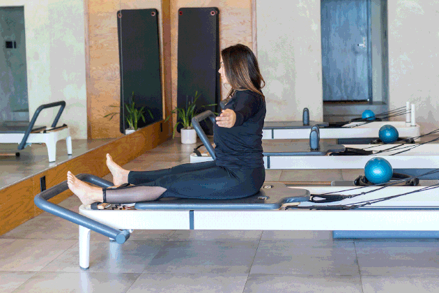 woman doing Saw on a Pilates reformer
