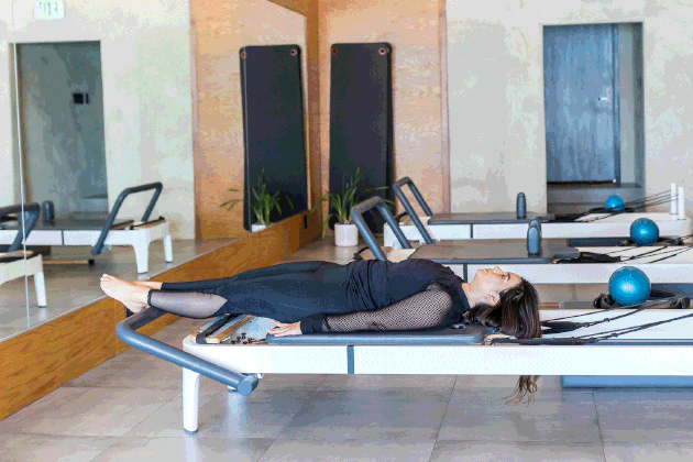 woman doing Leg Circles on a Pilates reformer