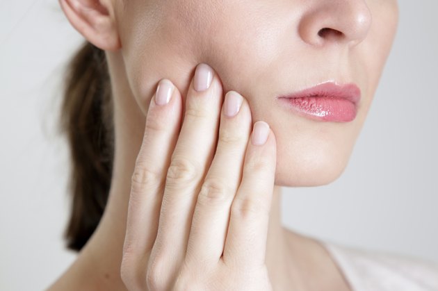 Close up of a women working her jaw.