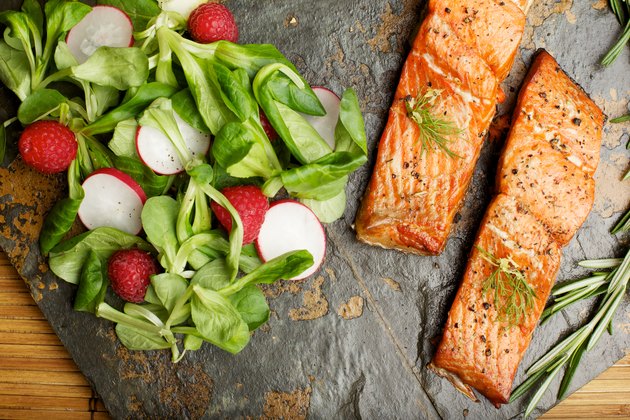 Slate tile plated grilled wild Salmon fillet arugula and couscous
