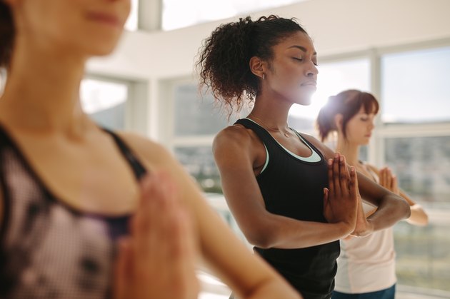 A group of women practicing yoga at the gym