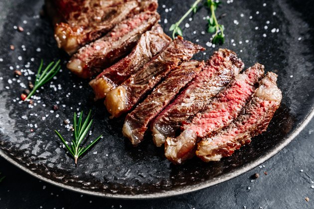 New York sirloin beef steak medium rare with rosemary top view