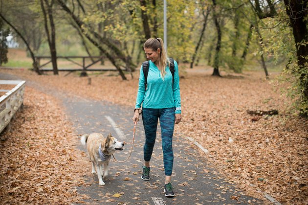 Woman walking with dog in park