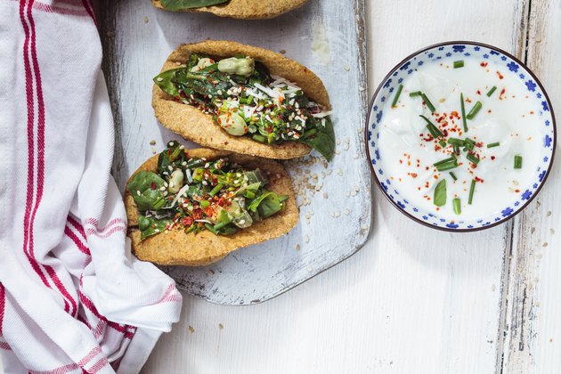 Vegetarian homemade tacos with sauteed greens, parmesan cheese, yogurt dipping sauce